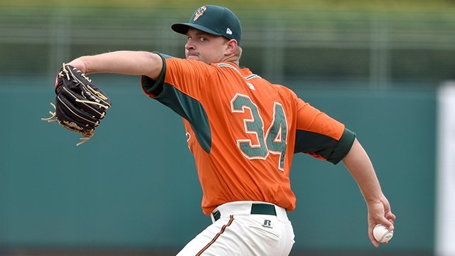 Miami Marlins first baseman Garrett Cooper (26) throws from the